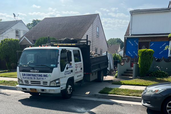 Working on exterior with view of company trucks in driveway